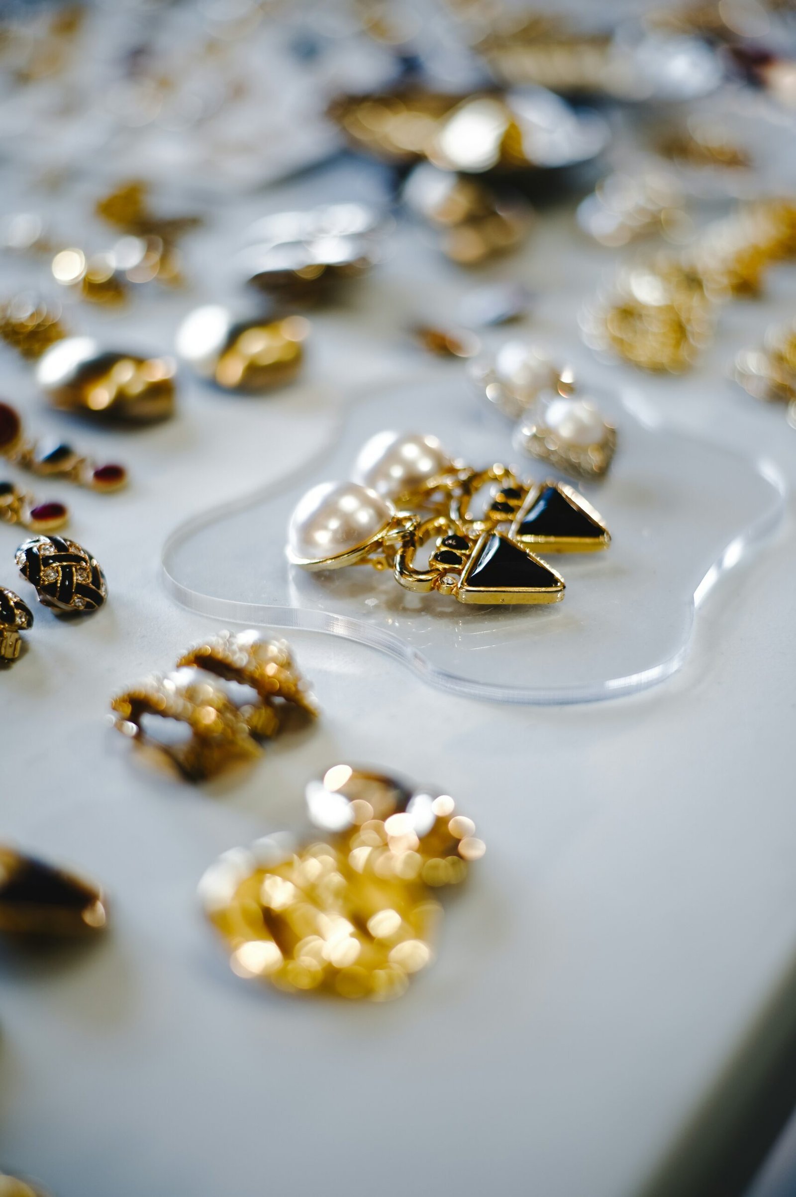 a table topped with lots of different types of jewelry